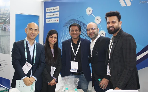 A group of five professionals standing together and smiling at DAISAKU booth in Bangladesh. Two people on the left from DAISAKU, and three clients on the right.